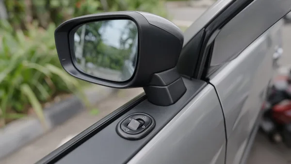 Foto spion samping MPV dengan sakelar pengatur di panel pintu